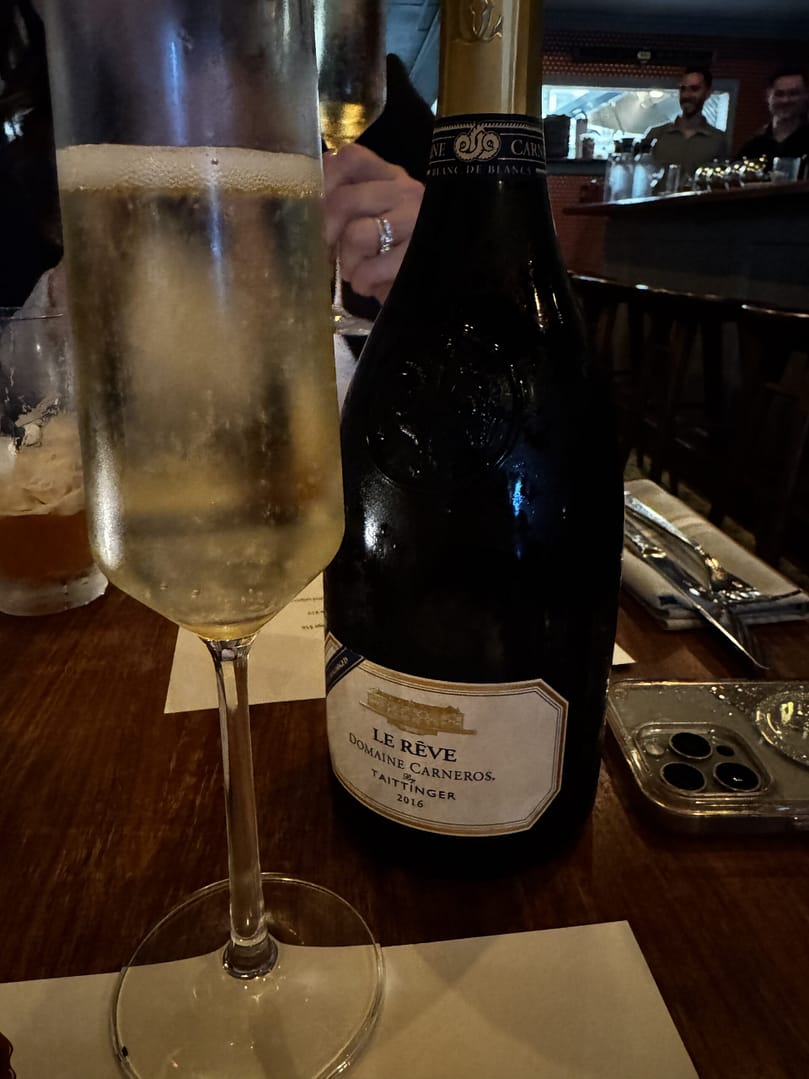 Bottle of Le Rêve Blanc de Blancs by Domaine Carneros by Taittinger, beside a champagne flute, at Circa 1918 in Hilton Village.